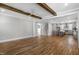 Open concept living room with hardwood floors, wooden beams, and a view of the kitchen at 210 Colvard Farms Rd, Durham, NC 27713