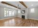 Spacious living room featuring hardwood floors, a fireplace and large windows for lots of natural light at 210 Colvard Farms Rd, Durham, NC 27713