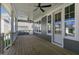 Spacious wooden porch with ceiling fans, white railing, and a view of the neighborhood at 210 Colvard Farms Rd, Durham, NC 27713