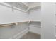A walk-in closet with carpet flooring, wooden rails and white shelving and walls, ready for ample storage at 210 Colvard Farms Rd, Durham, NC 27713