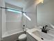 Bathroom with white vanity, shower/tub and modern black fixtures at 370 E Clydes Point Way, Wendell, NC 27591