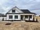 White farmhouse exterior with black accents and a covered porch at 370 E Clydes Point Way, Wendell, NC 27591