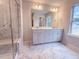 Well-lit bathroom with a double sink vanity, tiled shower, and a view from the window at 439 Duncan Creek Rd # 140, Lillington, NC 27546