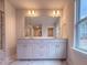 Bright bathroom features a double sink vanity, large mirror, and marble-tiled flooring and shower at 439 Duncan Creek Rd # 140, Lillington, NC 27546