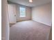 Bright bedroom features carpeting and a view to the outside through a window allowing ample natural light at 439 Duncan Creek Rd # 140, Lillington, NC 27546