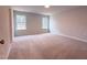 Spacious bedroom featuring plush carpeting, two windows, and neutral color palette at 439 Duncan Creek Rd # 140, Lillington, NC 27546
