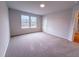 Airy bedroom featuring carpeting and ample natural light through multiple windows overlooking outdoor scenery at 439 Duncan Creek Rd # 140, Lillington, NC 27546