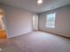 Bright bedroom features carpeting and an open door allowing view to the connecting rooms and ample natural light at 439 Duncan Creek Rd # 140, Lillington, NC 27546