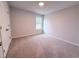 Clean bedroom with a window offering natural light and neutral walls complemented by carpet flooring at 439 Duncan Creek Rd # 140, Lillington, NC 27546