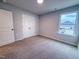 Cozy bedroom showcasing a double door closet and a window with a view of the neighborhood at 439 Duncan Creek Rd # 140, Lillington, NC 27546