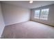 Bright bedroom offers carpeting and an open view to the neighborhood through the wide windows at 439 Duncan Creek Rd # 140, Lillington, NC 27546