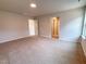 Neutral bedroom featuring carpet, large windows, and open access to other rooms at 439 Duncan Creek Rd # 140, Lillington, NC 27546