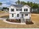 Charming two-story white home featuring a welcoming front porch and landscaped front yard at 439 Duncan Creek Rd # 140, Lillington, NC 27546