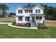Charming two-story home featuring white siding, black shutters and a well-manicured lawn on a sunny day at 439 Duncan Creek Rd # 140, Lillington, NC 27546