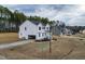 New construction with white siding, an attached garage, and professional landscaping at 439 Duncan Creek Rd # 140, Lillington, NC 27546