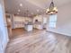 Spacious kitchen with modern appliances, white cabinetry, subway tile backsplash, and wood floors at 439 Duncan Creek Rd # 140, Lillington, NC 27546
