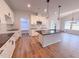 Bright open kitchen featuring white cabinets, black countertops, and a spacious center island at 439 Duncan Creek Rd # 140, Lillington, NC 27546