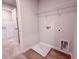 A spacious laundry room with laminate flooring, utility connections, and overhead wire shelving at 439 Duncan Creek Rd # 140, Lillington, NC 27546