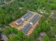 New construction townhomes featuring a modern exterior design and individual parking spaces, surrounded by lush greenery at 6402 Tanner Oak Ln, Raleigh, NC 27613
