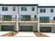 Townhomes featuring garage parking, sliding glass doors, and a private outdoor deck at 6402 Tanner Oak Ln, Raleigh, NC 27613