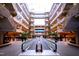 Shopping mall interior with escalators, multiple levels, natural light, and lush landscaping at 6402 Tanner Oak Ln, Raleigh, NC 27613