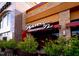 An exterior view of the Seasons 52 Fresh Grill, with stone accents and lush greenery at 6402 Tanner Oak Ln, Raleigh, NC 27613