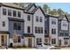 Modern townhouses showcase black trim, white and gray siding, and well-maintained landscaping at 6402 Tanner Oak Ln, Raleigh, NC 27613