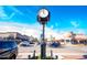 Street scene with retail shops, restaurants, and a prominent clock tower against a clear blue sky at 6402 Tanner Oak Ln, Raleigh, NC 27613