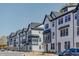 A line of modern townhouses along the street, with a blue sky in the background at 6402 Tanner Oak Ln, Raleigh, NC 27613