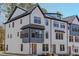 Charming three-story townhome featuring Hardie siding, black window accents, and an inviting entryway at 6408 Tanner Oak Ln, Raleigh, NC 27613