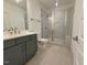 Modern bathroom with walk-in shower and dark vanity at 1045 Cabin Creek, Pittsboro, NC 27312