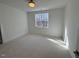 Bright bedroom with plush carpet and large window at 1045 Cabin Creek, Pittsboro, NC 27312