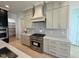 Stylish kitchen with range, custom cabinetry, and vent hood at 1045 Cabin Creek, Pittsboro, NC 27312