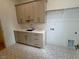 Laundry room with cabinets and patterned flooring at 1045 Cabin Creek, Pittsboro, NC 27312