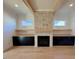 Living room with a stone fireplace and built-in shelving at 1045 Cabin Creek, Pittsboro, NC 27312