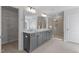 Primary bathroom with dual sinks, quartz counters, and a glass-enclosed shower at 130 Bold Dr, Youngsville, NC 27596