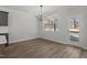 Bright dining room with wood floors, a modern chandelier, and a large window overlooking the backyard at 130 Bold Dr, Youngsville, NC 27596