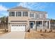 Charming two-story home with a manicured lawn, a two-car garage, and a covered front porch at 130 Bold Dr, Youngsville, NC 27596