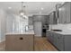 Modern kitchen with granite countertops, stainless steel appliances, a center island, and pendant lighting at 130 Bold Dr, Youngsville, NC 27596