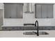 Close up of a modern kitchen with white subway tile backsplash and stainless steel range hood at 130 Bold Dr, Youngsville, NC 27596