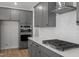 Contemporary kitchen with stainless steel appliances, gray cabinets, and a stylish range hood at 130 Bold Dr, Youngsville, NC 27596