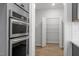 Stainless steel double ovens and a pantry with wire shelves for optimal kitchen storage at 130 Bold Dr, Youngsville, NC 27596
