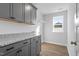 Well-equipped laundry room with gray cabinetry, granite countertops, and a practical layout at 130 Bold Dr, Youngsville, NC 27596