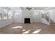 Bright and airy living room with a fireplace, a ceiling fan, and large windows at 130 Bold Dr, Youngsville, NC 27596