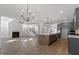 Open floor plan featuring a spacious living room, a fireplace, a kitchen with a large island at 130 Bold Dr, Youngsville, NC 27596