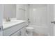 Bathroom featuring a single sink with grey cabinets, white countertop, white toilet, and shower with tub at 413 Edison Rail Ln, Knightdale, NC 27545