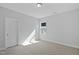 Bedroom featuring neutral carpet, white trim, grey walls, a window, and a closet at 413 Edison Rail Ln, Knightdale, NC 27545