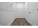Walk-in closet with wire shelving and hardwood floors at 413 Edison Rail Ln, Knightdale, NC 27545