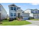 Beautiful two-story home with a gray exterior, complemented by well-manicured lawn and a two-car garage at 413 Edison Rail Ln, Knightdale, NC 27545