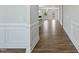 Hallway featuring hardwood floors and views to the living room with a fireplace and large windows at 413 Edison Rail Ln, Knightdale, NC 27545